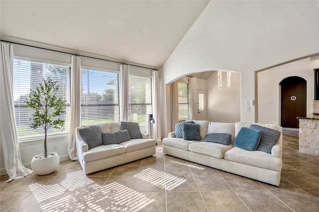 16206 Lakewood Field Dr, Tomball, TX 77377 - living area featuring arched walkways, tile patterned flooring, and high vaulted ceiling