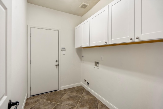 16206 Lakewood Field Dr, Tomball, TX 77377 - laundry area with cabinet space, hookup for an electric dryer, washer hookup, and dark tile patterned floors