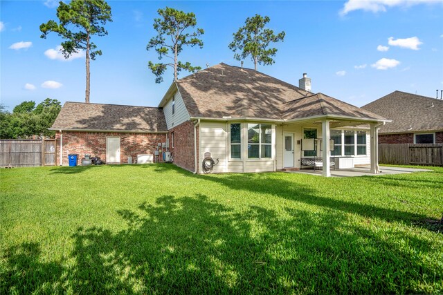 16206 Lakewood Field Dr, Tomball, TX 77377 - rear view of property featuring a patio area, a fenced backyard, brick siding, and a chimney