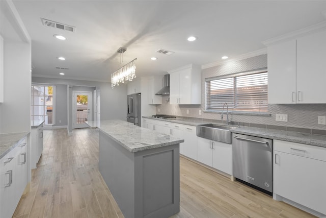 5110 Contour Pl, Houston, TX 77096 - kitchen featuring appliances with stainless steel finishes, crown molding, a kitchen island, wall chimney exhaust hood, and tasteful backsplash