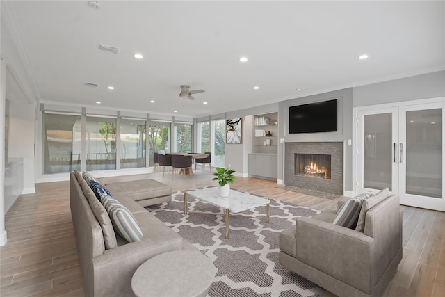 5110 Contour Pl, Houston, TX 77096 - living area featuring wood finished floors, recessed lighting, crown molding, ceiling fan, and a fireplace with flush hearth