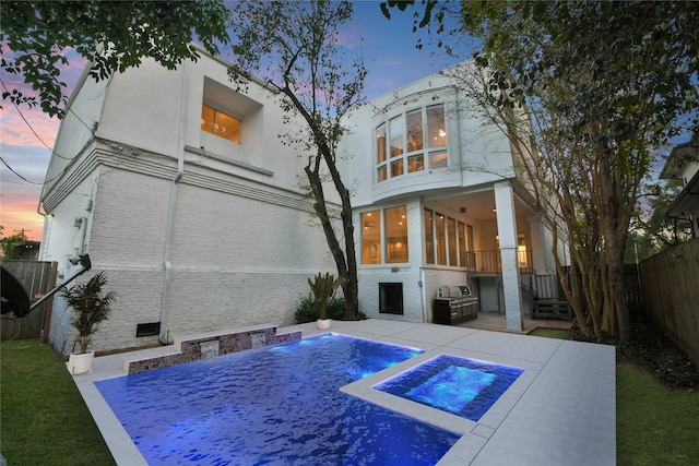 5110 Contour Pl, Houston, TX 77096 - back of property at dusk featuring a fenced backyard, brick siding, stucco siding, and a patio