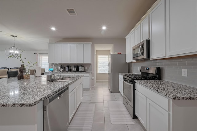 29626 Weber Way Ct, Katy, TX 77494 - kitchen with appliances with stainless steel finishes, decorative backsplash, white cabinets, and recessed lighting