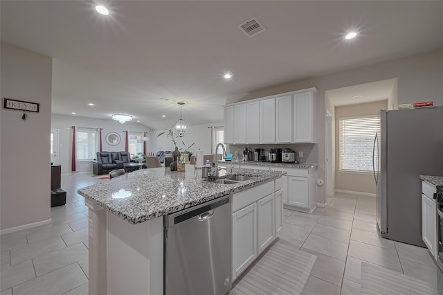 29626 Weber Way Ct, Katy, TX 77494 - kitchen with stainless steel dishwasher, freestanding refrigerator, recessed lighting, an island with sink, and open floor plan