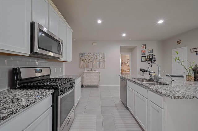 29626 Weber Way Ct, Katy, TX 77494 - kitchen with stainless steel appliances, tasteful backsplash, white cabinetry, light stone countertops, and recessed lighting