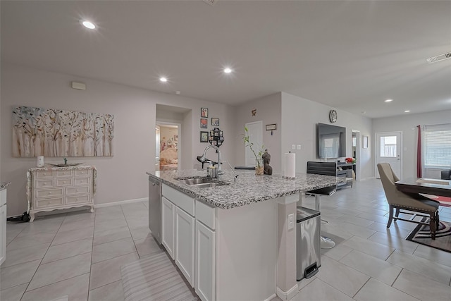 29626 Weber Way Ct, Katy, TX 77494 - kitchen with light tile patterned flooring, white cabinetry, light stone countertops, an island with sink, and recessed lighting