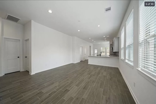 120 Lukewood Cir, Conroe, TX 77318 - unfurnished living room with dark wood finished floors and recessed lighting