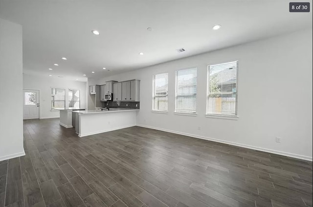 120 Lukewood Cir, Conroe, TX 77318 - unfurnished living room with recessed lighting and dark wood finished floors
