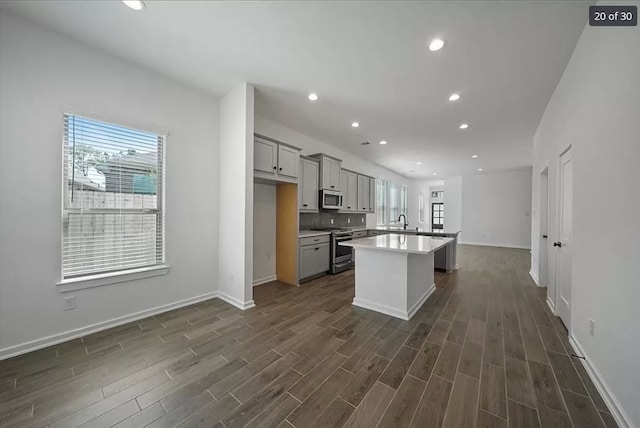 120 Lukewood Cir, Conroe, TX 77318 - kitchen featuring stainless steel appliances, gray cabinets, plenty of natural light, dark wood-type flooring, and recessed lighting