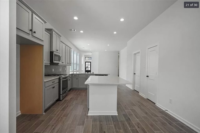 120 Lukewood Cir, Conroe, TX 77318 - kitchen with stainless steel appliances, gray cabinetry, dark wood-style floors, light countertops, and recessed lighting