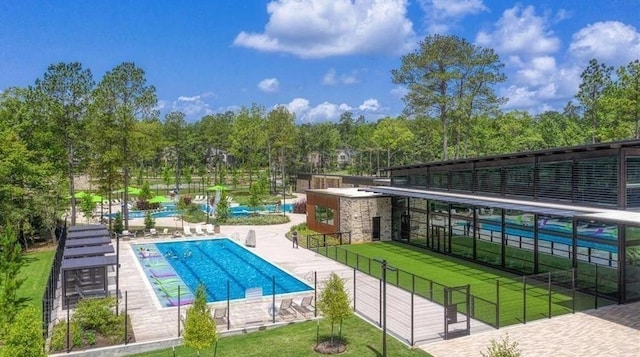 120 Lukewood Cir, Conroe, TX 77318 - community pool featuring a lawn and a patio area