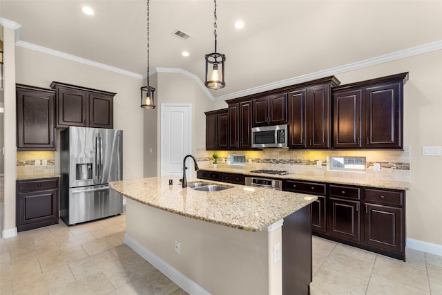 28647 Maple Red Dr, Katy, TX 77494 - kitchen featuring appliances with stainless steel finishes, tasteful backsplash, dark brown cabinets, a kitchen island with sink, and pendant lighting