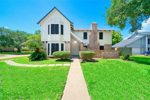 21434 Park Bluff Dr, Katy, TX 77450 - view of front facade with brick siding, a chimney, a front yard, and board and batten siding