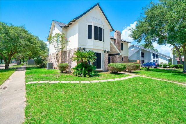 21434 Park Bluff Dr, Katy, TX 77450 - tudor home with a front lawn and brick siding