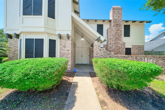 21434 Park Bluff Dr, Katy, TX 77450 - doorway to property featuring brick siding and a chimney