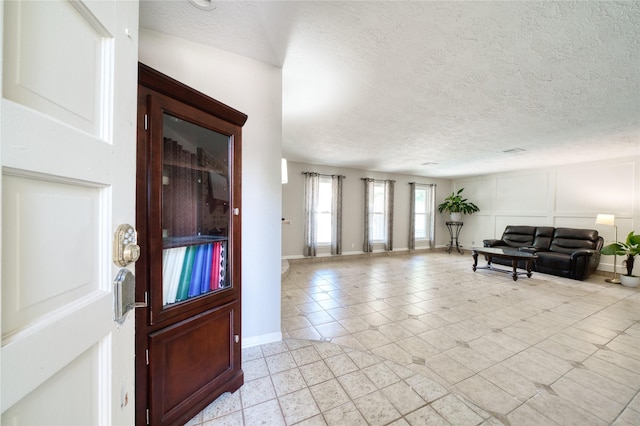 21434 Park Bluff Dr, Katy, TX 77450 - foyer with light tile patterned floors and a textured ceiling