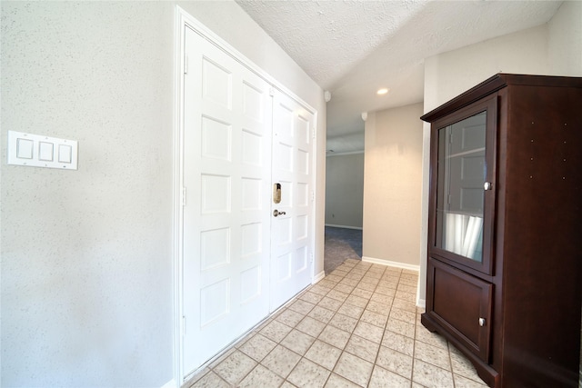 21434 Park Bluff Dr, Katy, TX 77450 - foyer featuring recessed lighting, a textured ceiling, and light tile patterned floors