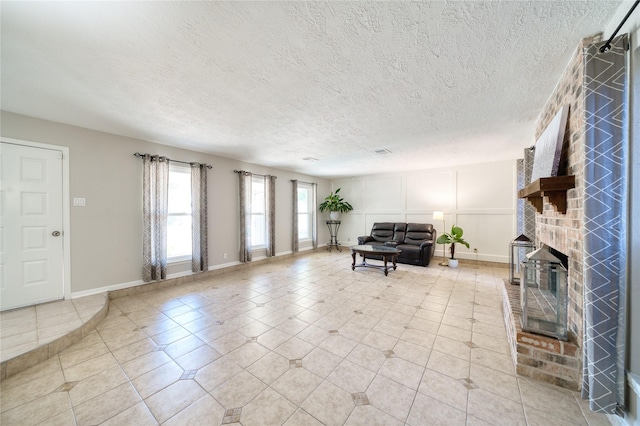 21434 Park Bluff Dr, Katy, TX 77450 - living area with a fireplace, a textured ceiling, and light tile patterned floors