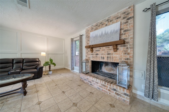 21434 Park Bluff Dr, Katy, TX 77450 - living room with a decorative wall, a fireplace, and a textured ceiling