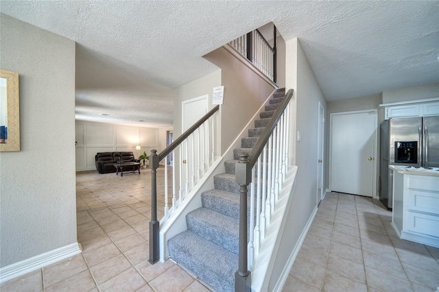 21434 Park Bluff Dr, Katy, TX 77450 - staircase with tile patterned flooring and a textured ceiling
