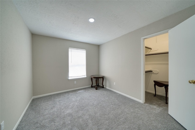21434 Park Bluff Dr, Katy, TX 77450 - unfurnished bedroom featuring a textured ceiling, carpet flooring, and a spacious closet