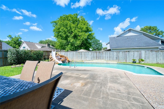 21434 Park Bluff Dr, Katy, TX 77450 - view of pool with a water slide, a patio, and a fenced backyard