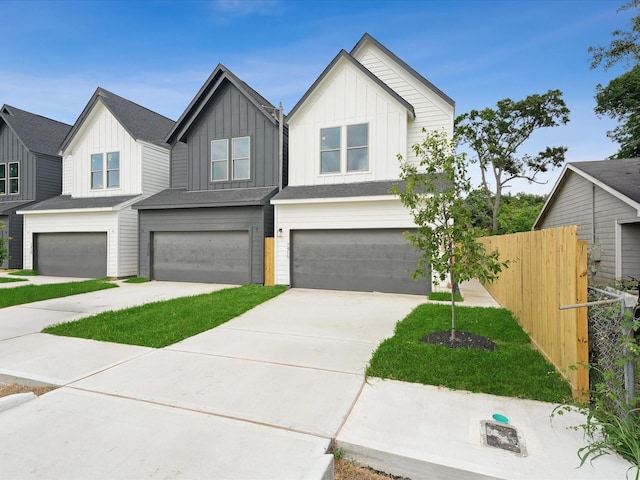 7420 Maxroy St, Houston, TX 77088 - view of front of house with an attached garage, board and batten siding, and driveway