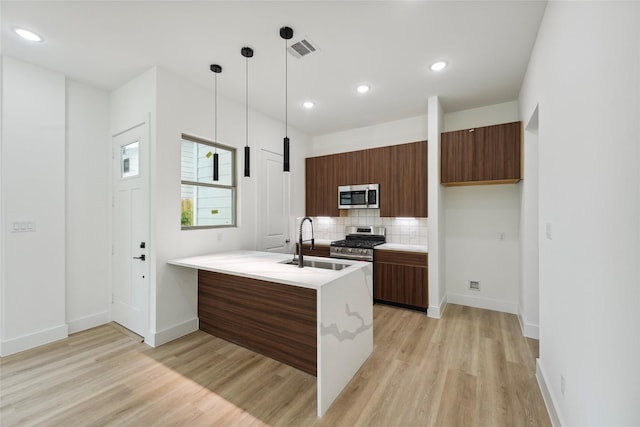 7420 Maxroy St, Houston, TX 77088 - kitchen featuring stainless steel appliances, modern cabinets, light countertops, a peninsula, and recessed lighting