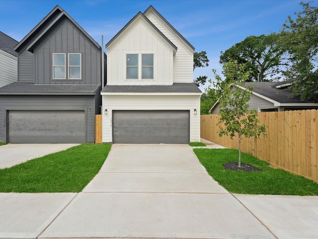7420 Maxroy St, Houston, TX 77088 - view of front of property featuring a garage, driveway, and board and batten siding