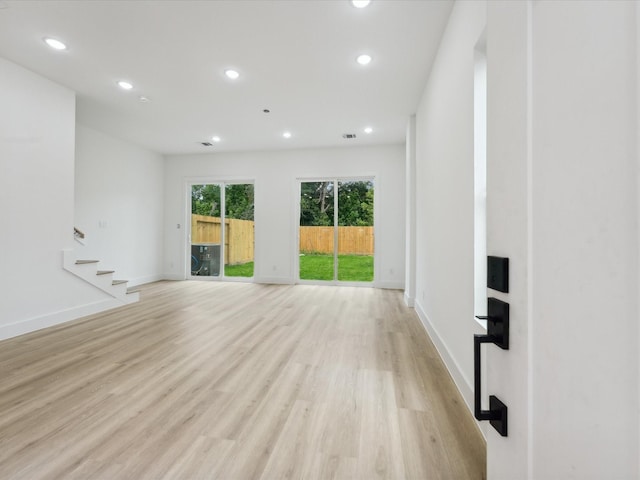 7420 Maxroy St, Houston, TX 77088 - unfurnished living room featuring recessed lighting, light wood finished floors, and stairway