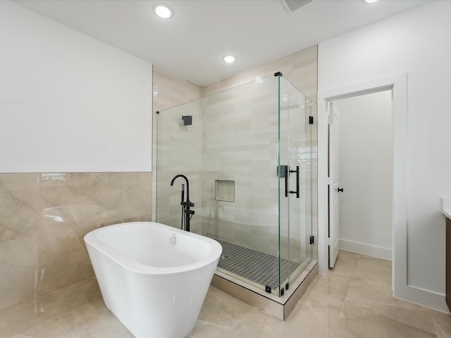 7420 Maxroy St, Houston, TX 77088 - bathroom featuring a soaking tub, a shower stall, recessed lighting, and vanity