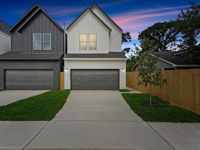 7420 Maxroy St, Houston, TX 77088 - view of front of home with an attached garage, concrete driveway, and board and batten siding
