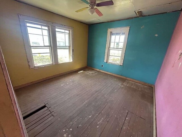 115 E Hallie St, Floydada, TX 79235 - spare room featuring wood-type flooring and ceiling fan