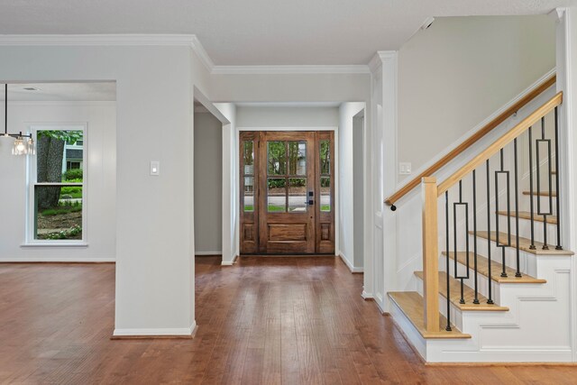 10813 Colony Wood Pl, The Woodlands, TX 77380 - foyer with wood finished floors, crown molding, stairway, and a chandelier