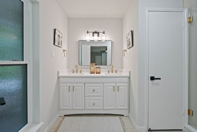10813 Colony Wood Pl, The Woodlands, TX 77380 - full bath with double vanity, a ceiling fan, and a shower with shower door