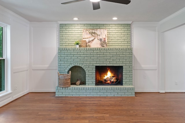 10813 Colony Wood Pl, The Woodlands, TX 77380 - unfurnished living room with a fireplace, wood finished floors, ceiling fan, and crown molding