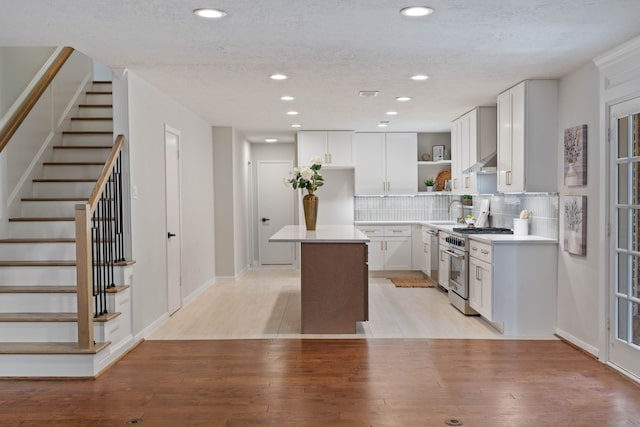 10813 Colony Wood Pl, The Woodlands, TX 77380 - kitchen with stainless steel appliances, open shelves, a kitchen island, recessed lighting, and white cabinets