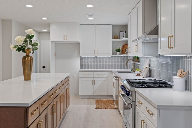 10813 Colony Wood Pl, The Woodlands, TX 77380 - kitchen featuring high end range, wall chimney range hood, open shelves, white cabinets, and light countertops
