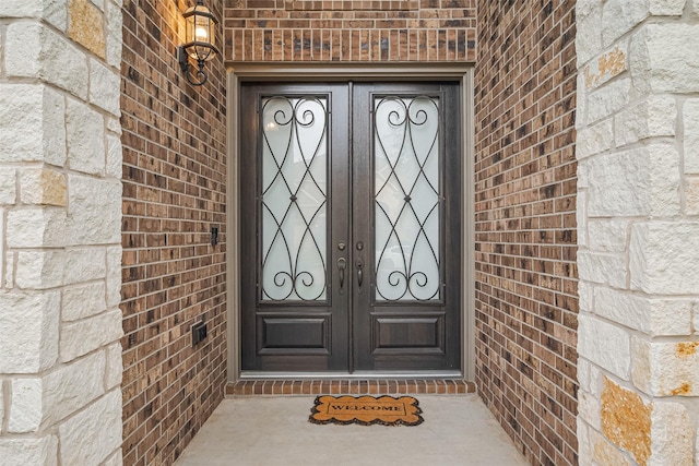11810 White Flint Ln, Cypress, TX 77433 - view of exterior entry with brick siding, french doors, and stone siding