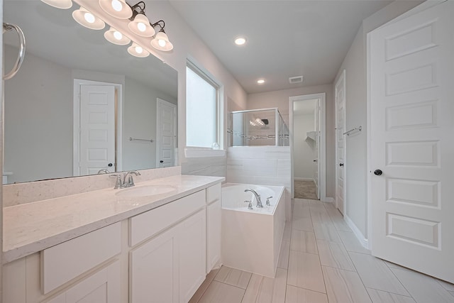 11810 White Flint Ln, Cypress, TX 77433 - full bathroom with a stall shower, vanity, a garden tub, and recessed lighting