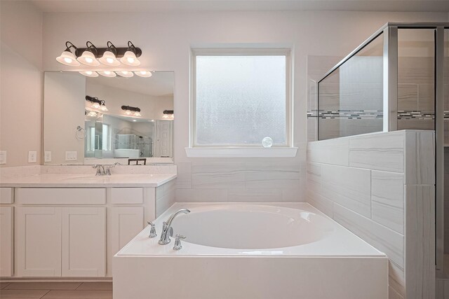 11810 White Flint Ln, Cypress, TX 77433 - bathroom featuring a garden tub, vanity, and tiled shower