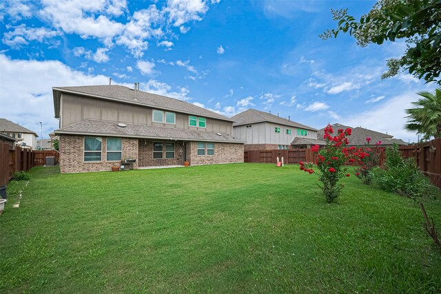 11810 White Flint Ln, Cypress, TX 77433 - rear view of house with a fenced backyard and brick siding