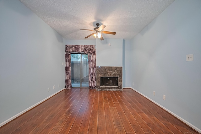 7900 N Stadium Dr Unit 123, Houston, TX 77030 - unfurnished living room with ceiling fan, a textured ceiling, wood finished floors, and a stone fireplace