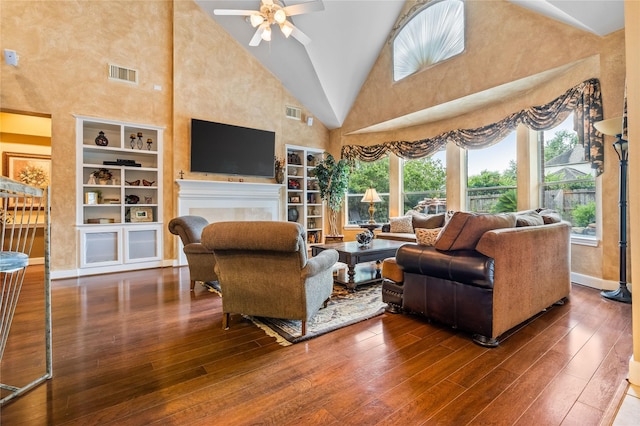 7914 Chianti Ct, Sugar Land, TX 77479 - living area featuring wood-type flooring, built in shelves, a fireplace, a ceiling fan, and high vaulted ceiling