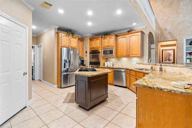 7914 Chianti Ct, Sugar Land, TX 77479 - kitchen featuring stainless steel appliances, crown molding, arched walkways, light stone counters, and decorative backsplash