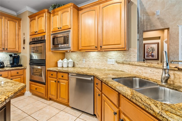 7914 Chianti Ct, Sugar Land, TX 77479 - kitchen with appliances with stainless steel finishes, decorative backsplash, light tile patterned floors, crown molding, and light stone countertops