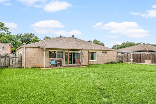 735 Red Rock Canyon Dr, Katy, TX 77450 - back of house with brick siding, a fenced backyard, a shingled roof, and a patio area