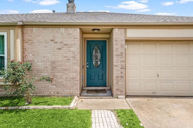 735 Red Rock Canyon Dr, Katy, TX 77450 - view of exterior entry featuring brick siding and a shingled roof