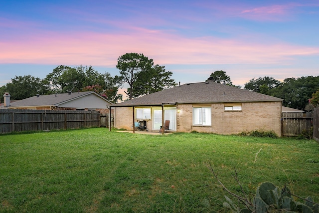 735 Red Rock Canyon Dr, Katy, TX 77450 - back of property at dusk featuring a fenced backyard and brick siding