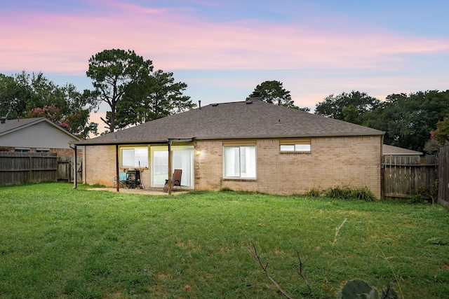 735 Red Rock Canyon Dr, Katy, TX 77450 - back of property at dusk featuring a fenced backyard and brick siding